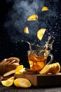 falling slices of lemons into a mug with hot tea, steam rises above the mug Royalty Free Stock Photo