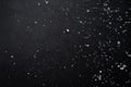 Falling  snow at night. Bokeh lights on black background, flying snowflakes in the air. Overlay texture. Snowstorm. Royalty Free Stock Photo