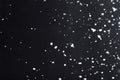 Falling  snow at night. Bokeh lights on black background, flying snowflakes in the air. Overlay texture. Snowstorm Royalty Free Stock Photo