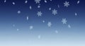 Falling snowflakes on a gradient blue background. The snowflakes vary in size and shape, featuring Royalty Free Stock Photo