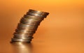 Falling stack of coins on a golden background