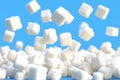 Falling Sugar Cubes against Blue Sky Shows Sweetness Concept and Consumption Royalty Free Stock Photo