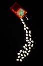 Falling tic tacs isolated on dark background. Royalty Free Stock Photo