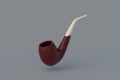 Falling tobacco pipe on gray background Royalty Free Stock Photo