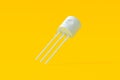 Falling transistor on orange background. Electronic component Royalty Free Stock Photo