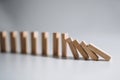 Falling Wooden Dominoes Representing Chain Reaction and Cause-Effect Concept. Royalty Free Stock Photo