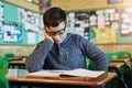 He always falls asleep when reading that book in class. an elementary school boy sleeping at his desk in class. Royalty Free Stock Photo