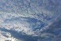 Fallstreak hole cloud on dramatic blue sky