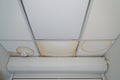 False ceiling leaks. Yellow dirty stains from the pipe break. Emergency situation, destruction of the roof