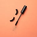 False eyelashes and mascara on orange background Royalty Free Stock Photo