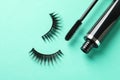 False eyelashes and mascara on turquoise background Royalty Free Stock Photo