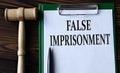 FALSE IMPRISONMENT - words on a white sheet with a judge\'s gavel Royalty Free Stock Photo