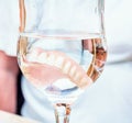 False teeth in glass of water Royalty Free Stock Photo