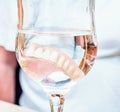 False teeth in glass of water