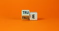 False or true symbol. Turned a wooden cube and changed the word `false` to `true` or vice versa. Beautiful orange table, orang Royalty Free Stock Photo