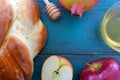 Falt lay view of Round sweet challah, honey jar, red apple and p