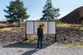 Falun, Dalarna - Sweden -Tourist visiting the Falun cuppermine, looking at an indication sign