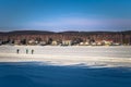 Falun - March 31, 2018: Hikers at the frozen lake of Framby Udde near the town of Falun in Dalarna, Sweden