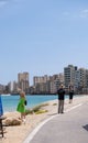 People gaze at the beach of the abandoned city of the ghost city of Varosha Famagusta on a sunny day