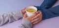 Hands holding a papern cup with broth soup Royalty Free Stock Photo