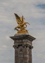 `Fames`, gilt-bronze statues of Fames over the Pont Alexandre III deck arch bridge