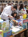 Families buying books during books day in mallorca vertical