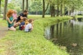 Families with children close to a waterscape with duck on it Royalty Free Stock Photo