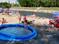 Families with children sunbathing at the river banks