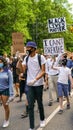 Families holding signs in a protest march