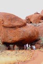 Families visit a cave in Uluru Ayers Rock, Australia