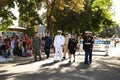 Families watch US military veterans walk past at a fourth of July parade.