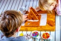 Familiy building a sweet ginger bread house