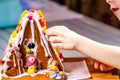 Familiy building a sweet ginger bread house