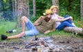 Family activity for summer vacation in forest and nature. Family relaxing near bonfire after day of mushroom hunting Royalty Free Stock Photo