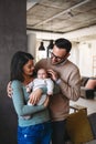 Family, adoption, baby, parenthood and people concept. Happy mother father with newborn baby at home Royalty Free Stock Photo