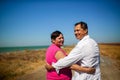 Family, age and people concept - happy senior couple holding hands talking outdoors Royalty Free Stock Photo