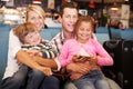 Family In Airport Departure Lounge Waiting To Go On Vacation Royalty Free Stock Photo