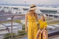 Family at airport before flight. Mother and son waiting to board at departure gate of modern international terminal Royalty Free Stock Photo