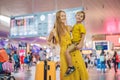 Family at airport before flight. Mother and son waiting to board at departure gate of modern international terminal Royalty Free Stock Photo