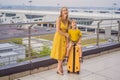 Family at airport before flight. Mother and son waiting to board at departure gate of modern international terminal Royalty Free Stock Photo