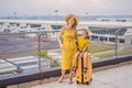 Family at airport before flight. Mother and son waiting to board at departure gate of modern international terminal Royalty Free Stock Photo