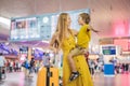 Family at airport before flight. Mother and son waiting to board at departure gate of modern international terminal Royalty Free Stock Photo