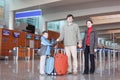 Family in airport hall with suitcases full bod Royalty Free Stock Photo