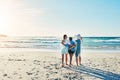 Family is all you need. Rearview shot of a senior woman spending the day at the beach with her daughter and Royalty Free Stock Photo