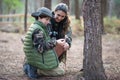 Family of amateur photographers in forest