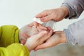 Family applying hand sanitizer to clean and disinfect hands. People disinfecting hands with antiseptic spray