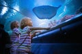 Family in aquarium. Kids watch fish, marine life Royalty Free Stock Photo