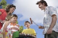 Family Around Grill In Garden Royalty Free Stock Photo