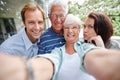 Family is as family does. four adults taking a family selfie.