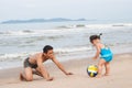 Family.Asian baby girl and father playing football on the beach. Royalty Free Stock Photo